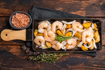 Fototapeta premium Seafood Cocktail appetiser with Mussels, Clams, Prawns, Shrimps and squid. wooden background. top view