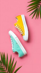Stylish pastel sneakers yellow and teal canvas shoes on pink background flat lay fashion