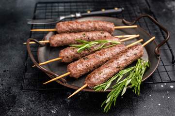 Grilled minced beef and lamb kebabs skewers with fresh spices, arabic kofta kofte kebab. black...