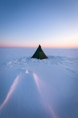 Winter camping tent in snow landscape at sunset adventure travel outdoor recreation