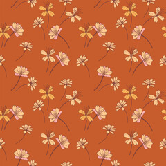 Seamless vector floral pattern with delicate hand drawn pink and yellow flowers on a warm terracotta background. Template for textiles, packaging, and wallpapers.