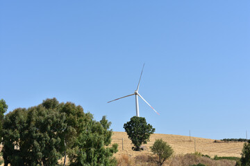 Wind turbine on the mountain in Sicily, Italy. Wind turbine and countryside Italian summer...