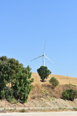 Wind turbine on the mountain in Sicily, Italy. Wind turbine and countryside Italian summer...
