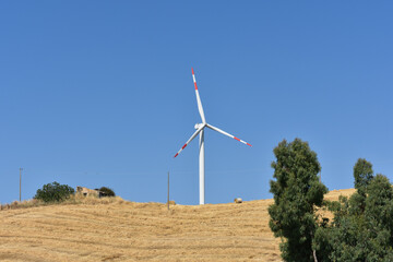 Wind turbine on the mountain in Sicily, Italy. Wind turbine and countryside Italian summer...