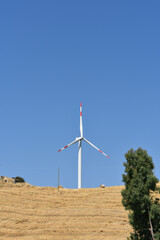 Wind turbine on the mountain in Sicily, Italy. Wind turbine and countryside Italian summer...