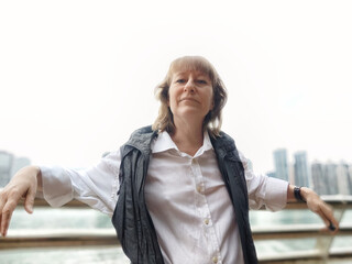 Blonde woman enjoying a tranquil moment while blogging about her travel experiences in Hong Kong