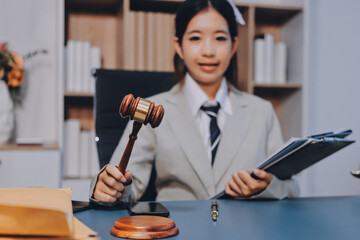 Judge gavel with Justice lawyers having team meeting at law firm background. Concepts of Law and...