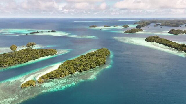Epic aerial clip revealing the crystal blue waters and islands within Palau&rsquo;s archipelago. Wide cinematic revealing drone shot.