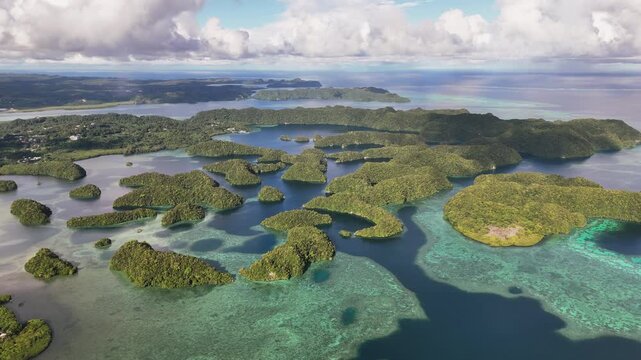 Epic cinematic drone shot sweeping across the crystal blue waters and islands of Palau. Revealing orbiting aerial drone shot.