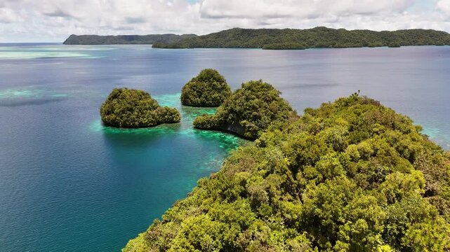 Epic cinematic aerial drone shot of crystal blue waters and islands in Palau.