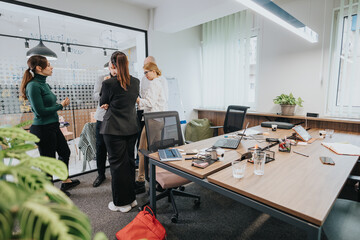 A group of associates collaborating in a modern office space, engaging in discussions and...