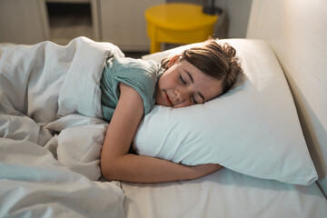 Child in a bedroom before going to sleep.
