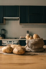 Raw organic potatoes in a burlap sack on a kitchen table. Natural vegetables in a rustic setting...