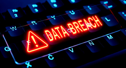 Glowing Red Data Breach Warning Sign on Illuminated Computer Keyboard image