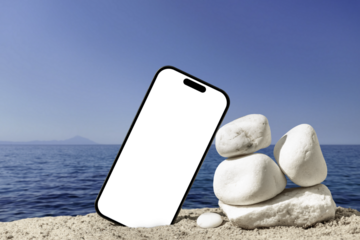 Smartphone with white screen on the beach by the sea