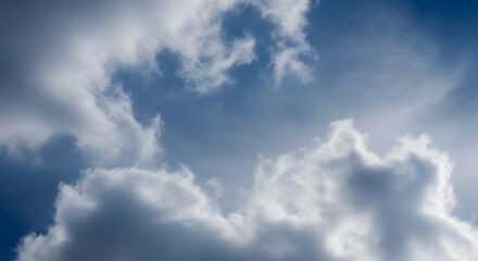 Fototapeta premium A captivating view of fluffy white clouds scattered across a serene blue sky expanse