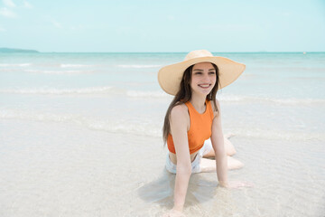 Happy beautiful young woman smiling at the beach side - Delightful girl enjoying sunny day. Summer holiday fashion concept. Young fashion woman relax on the beach.	

