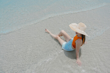 Happy beautiful young woman smiling at the beach side - Delightful girl enjoying sunny day. Summer holiday fashion concept. Young fashion woman relax on the beach.	
