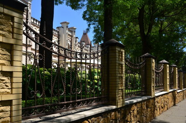 view of a beautiful sanatorium in Essentuki, Russia, through an openwork metal fence