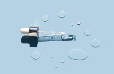 pipette serum round drops of transparent gel serum on blue background