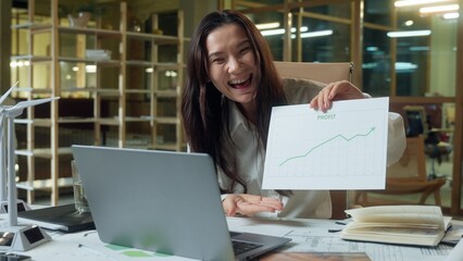 Asian businesswoman business woman call video conference laptop in office happy girl analyst Chinese Korean female trader data presentation graph finance increase growth sales income profit success