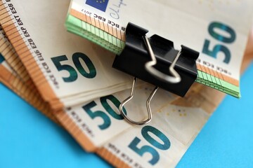 Big amount of european euro currency money notes on blue color table close up