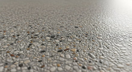 Close up of a speckled surface with small stones and pebbles in a gray concrete background texture