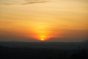 Sunrise in Khao Yai, Thailand. Majestic sunrise over the mountains. Colorfull sunrise on foggy day over Tipperary mountains and fields. Beautiful sunshine at misty morning mountains.
