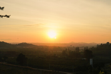 Obraz premium Sunrise in Khao Yai, Thailand. Majestic sunrise over the mountains. Colorfull sunrise on foggy day over Tipperary mountains and fields. Beautiful sunshine at misty morning mountains.