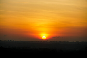 Sunrise in Khao Yai, Thailand. Majestic sunrise over the mountains. Colorfull sunrise on foggy day over Tipperary mountains and fields. Beautiful sunshine at misty morning mountains.