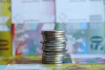 Swiss franc banknotes and coins. The current francs money bills and coins lies in big amount