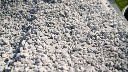 Gardener pouring gravel into pot