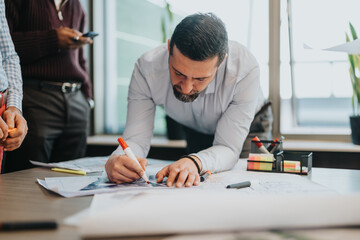 Business individuals in a modern office engage in collaborative work on a project, highlighting...