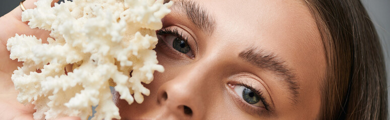 Young woman radiates beauty with natural makeup in summertime studio setting