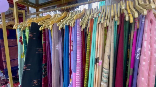 Colorful Traditional Indian Sarees Hanging on Display Rack