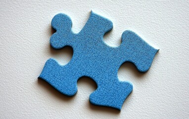 Fototapeta premium A solitary blue puzzle piece on a crisp white background.