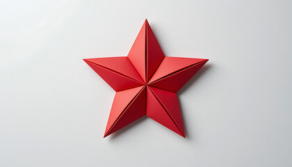 Handcrafted red paper star in origami style on white.
