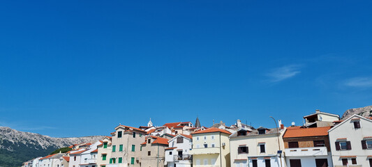 A view of the traditional houses of Baska on Krk Island, with characteristic tiled roofs and...
