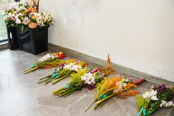 Flowers used for flower arrangement are placed on the ground