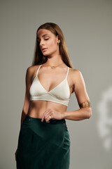 Summertime elegance: a young woman in a stylish studio, showcasing natural beauty