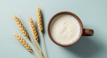Rustic Ceramic Cup of Oat Milk with Wheat Stalks on Light Blue Background – Minimalist Vegan Drink Concept