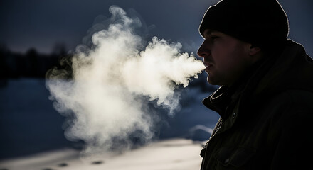 A man exhaling vapor in cold weather wearing a hat and jacket near a body of water in winter