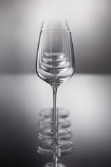 Set of wine glasses  on a gray reflective background. Shallow depth of  field.