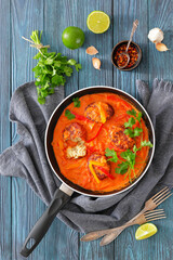 fish cakes in tomato vegetable coconut milk sauce