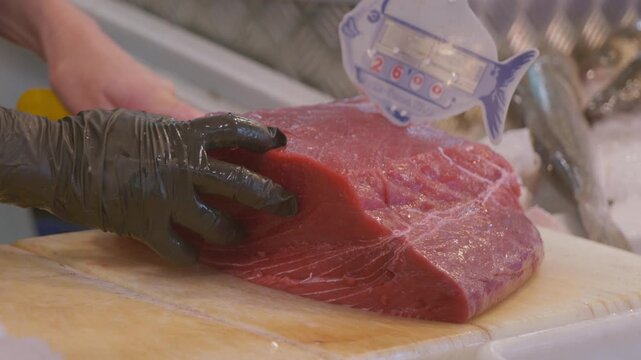 Process of cutting a piece of bluefin tuna, at the Barbate Food Market