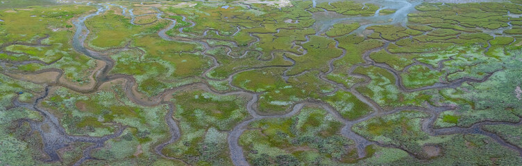 Aerial view from a drone of the low tide landscape in Santoña, in the marshes of the Santoña, Victoria, and Joyel Marshes Natural Park. Cantabrian Sea. Cantabria. Spain. Europe.