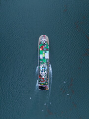 Aerial view of a fishing boat in Santoña, in the marshes of the Santoña, Victoria, and Joyel Marshes Natural Park. Cantabrian Sea. Cantabria. Spain. Europe.