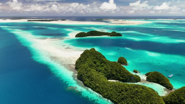 Scenic cinematic aerial drone shot hovering and circling the glowing waters and emerald islands of Palau. Wide cinematic orbiting shot