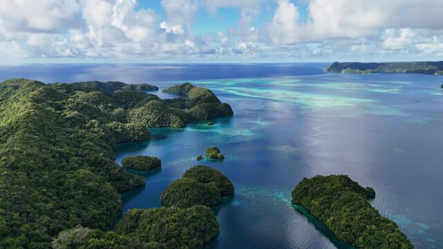 Stunning drone footage revealing the surreal ocean hues and remote islands in Palau. Wide cinematic revealing drone shot.