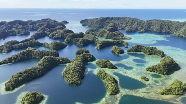 Cinematic aerial footage showcasing remote islands around Palau and tropical waters. Wide drone shot.